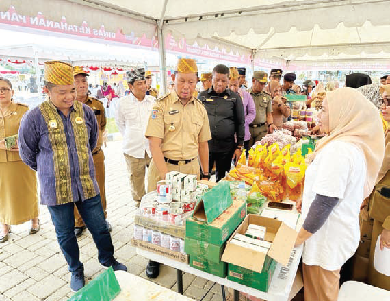 STOK PANGAN AMAN : Pj Wali Kota Kendari, Asmawa Tosepu (kedua dari kanan) meninjau pelaksanaan pasar murah di Pelataran Balai Kota Kendari, kemarin. (AGUS SETIAWAN/KENDARI POS)