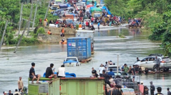 Kondisi ruas jalan trans Sulawesi yang digenangi banjir di Desa Samandete Kecamata Oheo. Penyebab banjir akibat intensitas curah hujan yang tinggi yang menyebabkan sungai Lalindu dan sungai Lasolo meluap hingga ke badan jalan trans Sulawesi. (HELMIN TOSUKI / KENDARI POS)