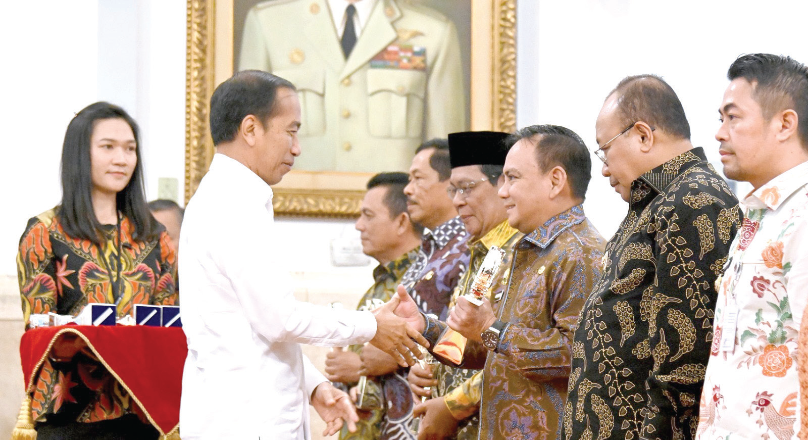 Presiden Jokowi (kiri) menyerahkan trofi penghargaan TPID Award 2024 kepada Pj Gubernur Sultra Andap Budhi Revianto (3 dari kanan) di Istana Negara.